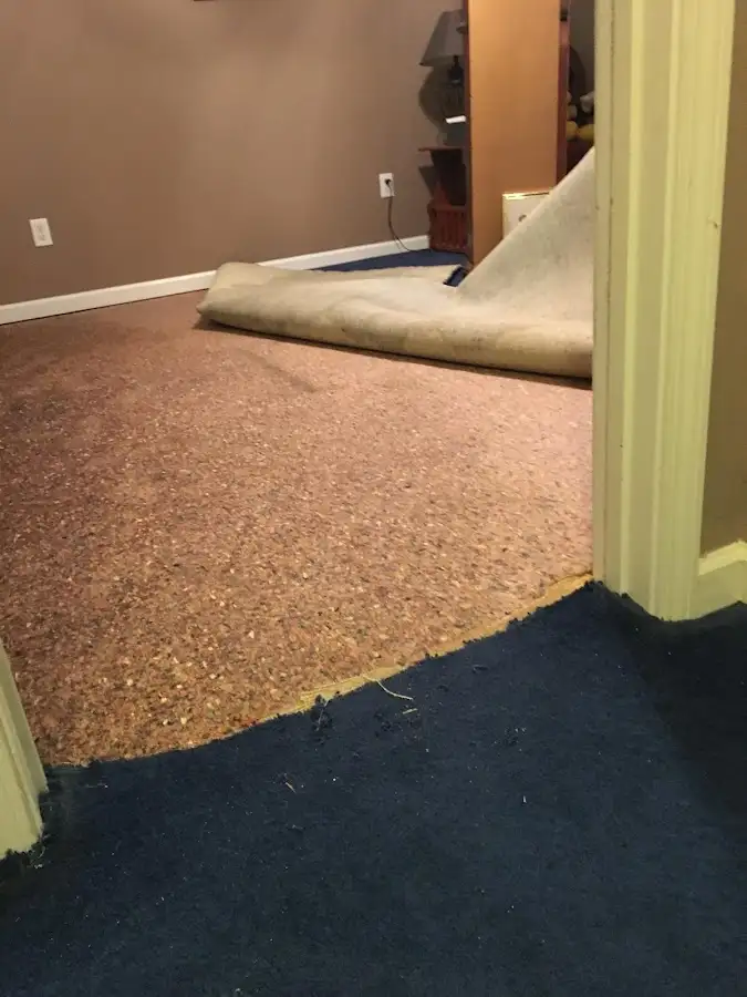 Carpet pad removal revealing water damage during Water Mitigation Services in Yukon